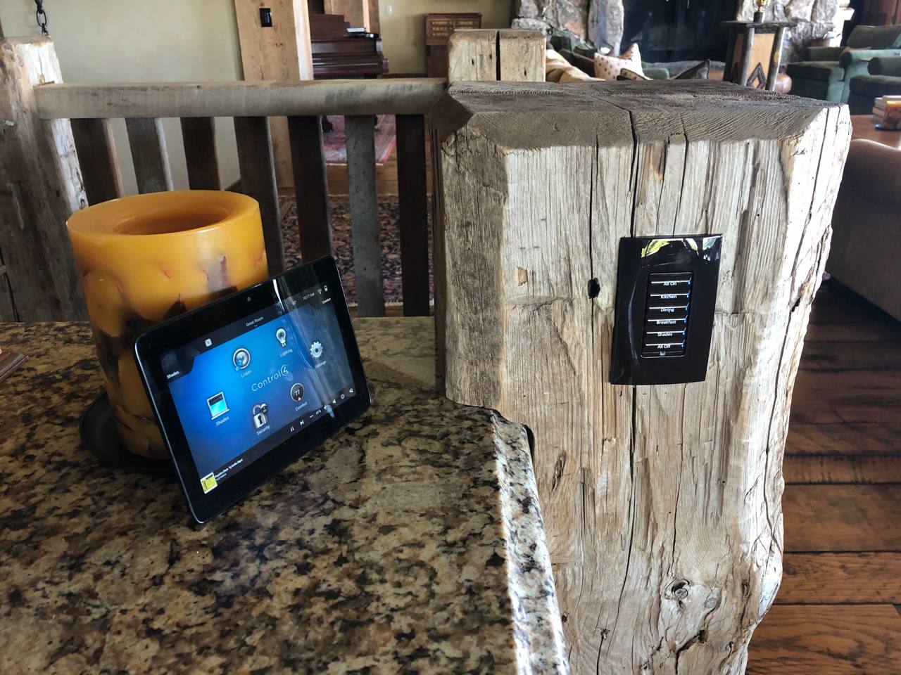 Control4 tablet and keypad on reclaimed wood post — rustic luxury automation