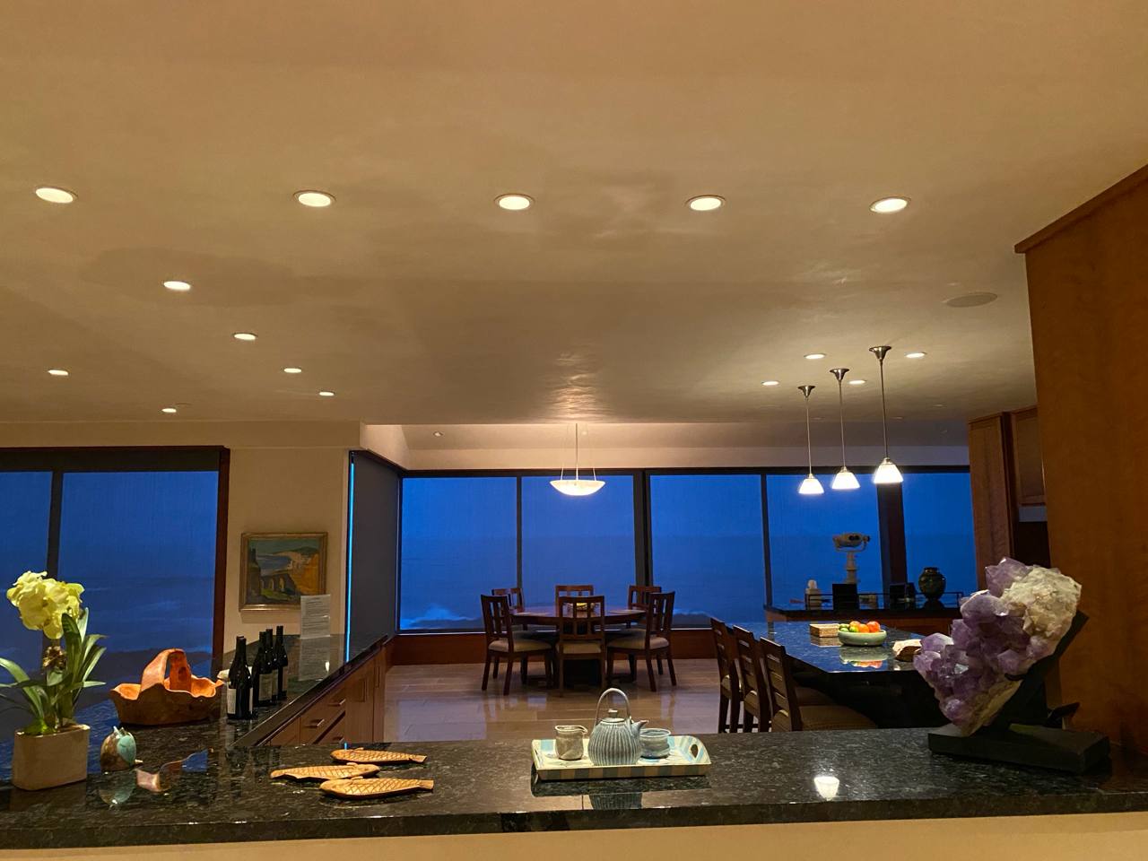 Dusk dining — ocean view, telescope, amethyst, pendant lights, granite counter