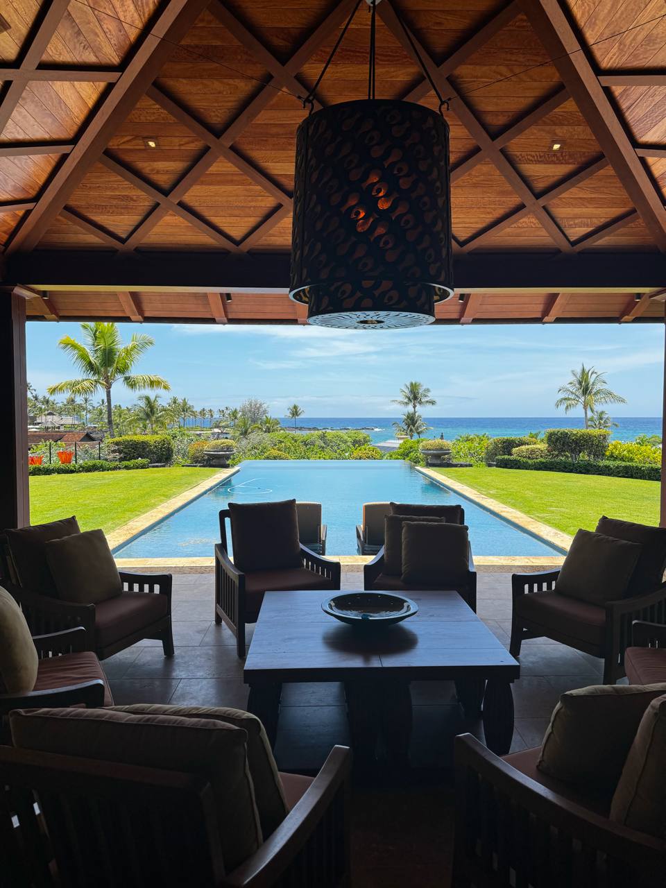 Infinity pool to ocean — outdoor pavilion, koa ceiling, pendant light