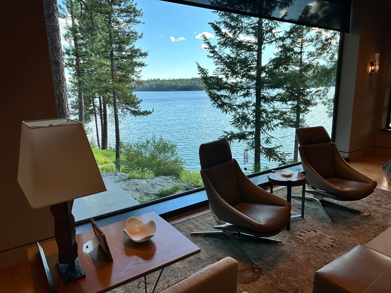 McCall Idaho — lakeside living room, leather swivels, floor-to-ceiling glass, Payette Lake