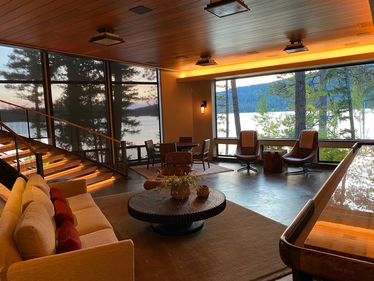 McCall ID — lakeside living room at dusk, LED staircase, floor-to-ceiling glass, cedar ceiling