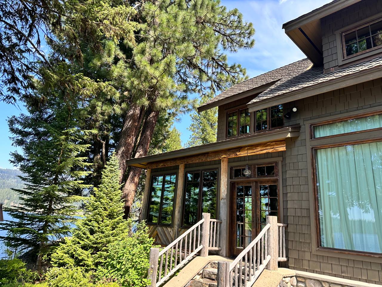 McCall Idaho — craftsman mountain lodge, shingle siding, log posts, pines, lake glimpse