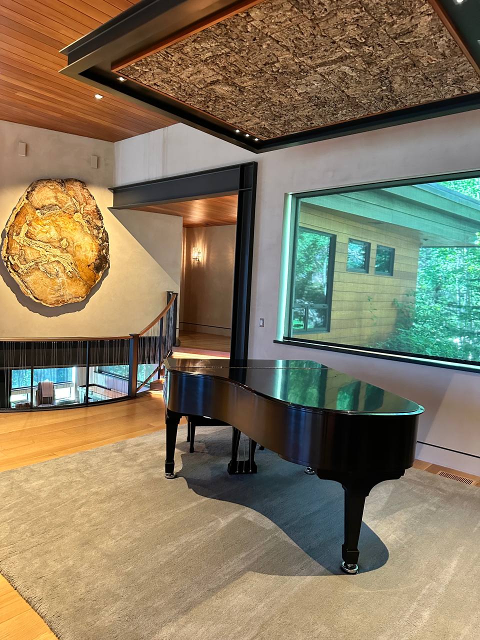 McCall Idaho — grand piano, petrified wood art, cedar ceiling, cork accent panel, mezzanine