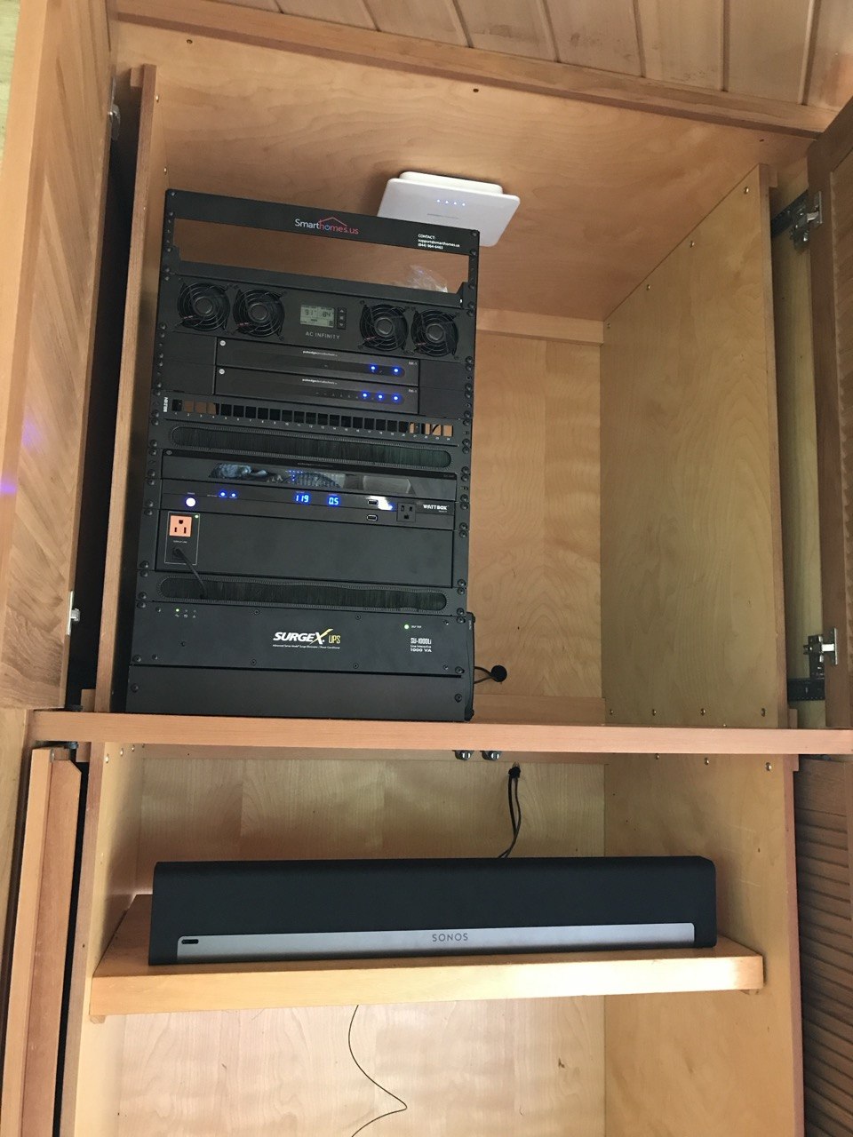 SmartHomes.us branded rack — AC Infinity, WattBox, SurgeX, Sonos, network switches